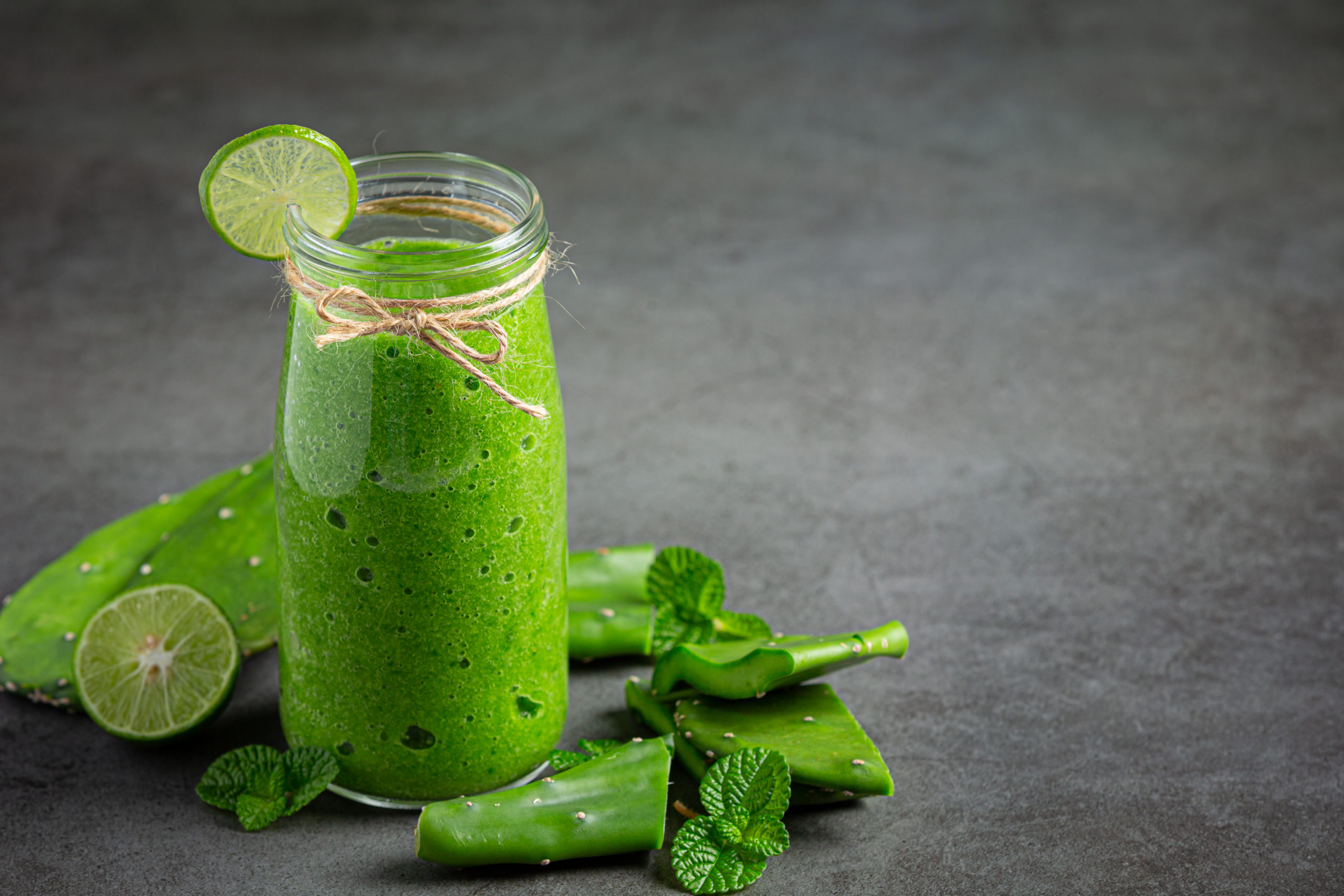 a glass of aloe vera  juice put on dark floor