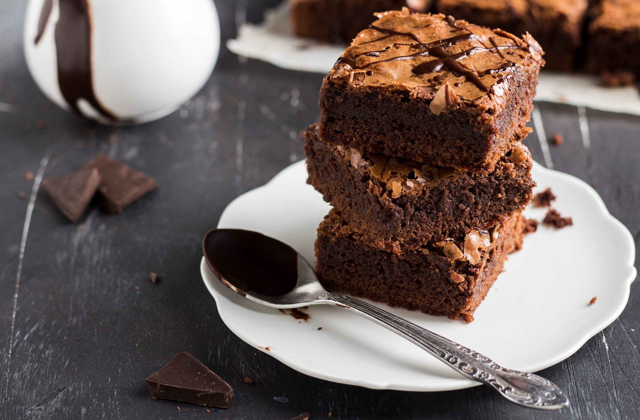 Chocolate brownie cake piece stack on plate homemade pastries sweet cooking with melted chocolate on dark background